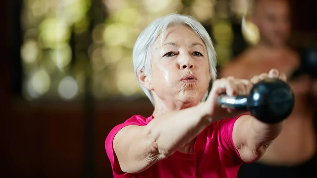 Toning Arms Without the Bulk: Is It Achievable? 1 Woman doing resistance band exercises for toned arms Derbyshire